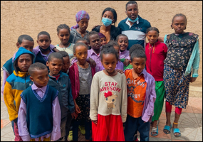 UC student with children in Ethiopia