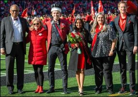 Xander Wells (third from left) was named the 2022 UC Homecoming King. With Wells (from left to right) are UC President Neville Pinto, PhD; UC Foundation Trustee Ruthie Keefe; Homecoming Queen Naomi Dias, BBA, BS ’23; First Lady Jennifer Pinto, PhD; and UC Director of Athletics John Cunningham. Photo/Lauren Meisberger.